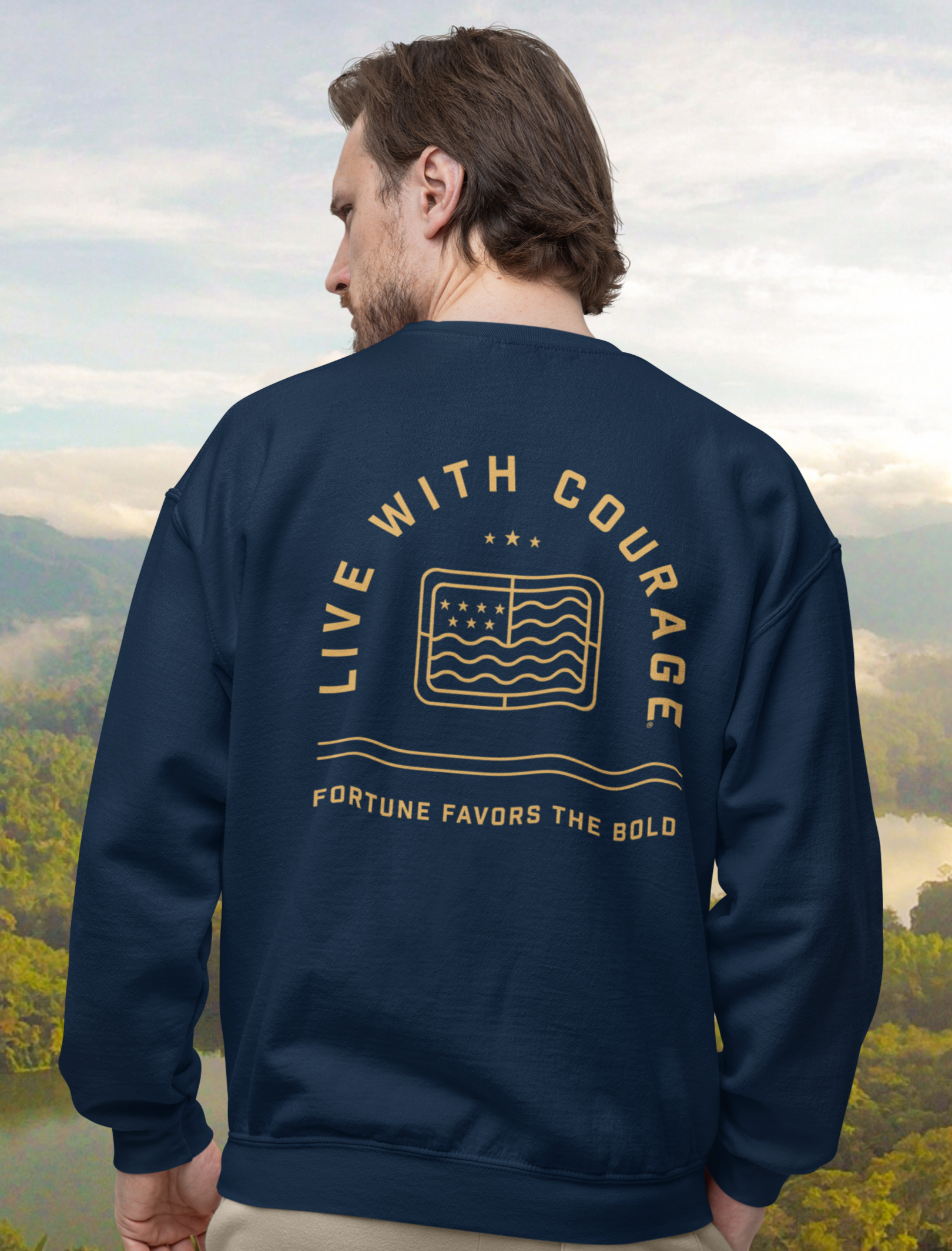 A person wearing a navy blue crewneck sweatshirt with the 'Live With Courage' logo printed on the back.