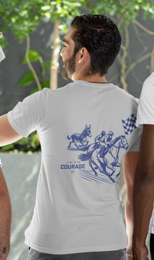 Man wearing a white tee shirt with a picture of a horse race with two horses and a mule racing and the words Live With Courage.