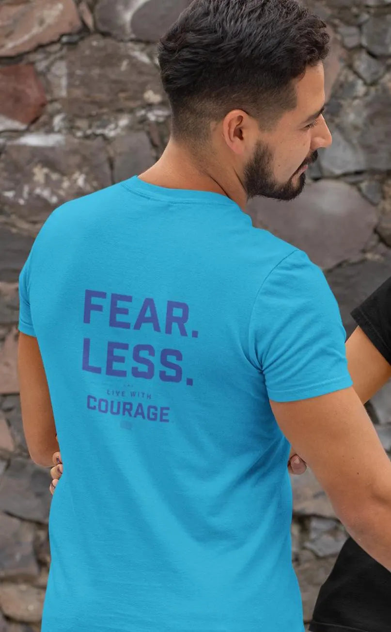 A person wearing a blue crew neck t-shirt with the text 'FEAR. LESS. COURAGE' on the back.